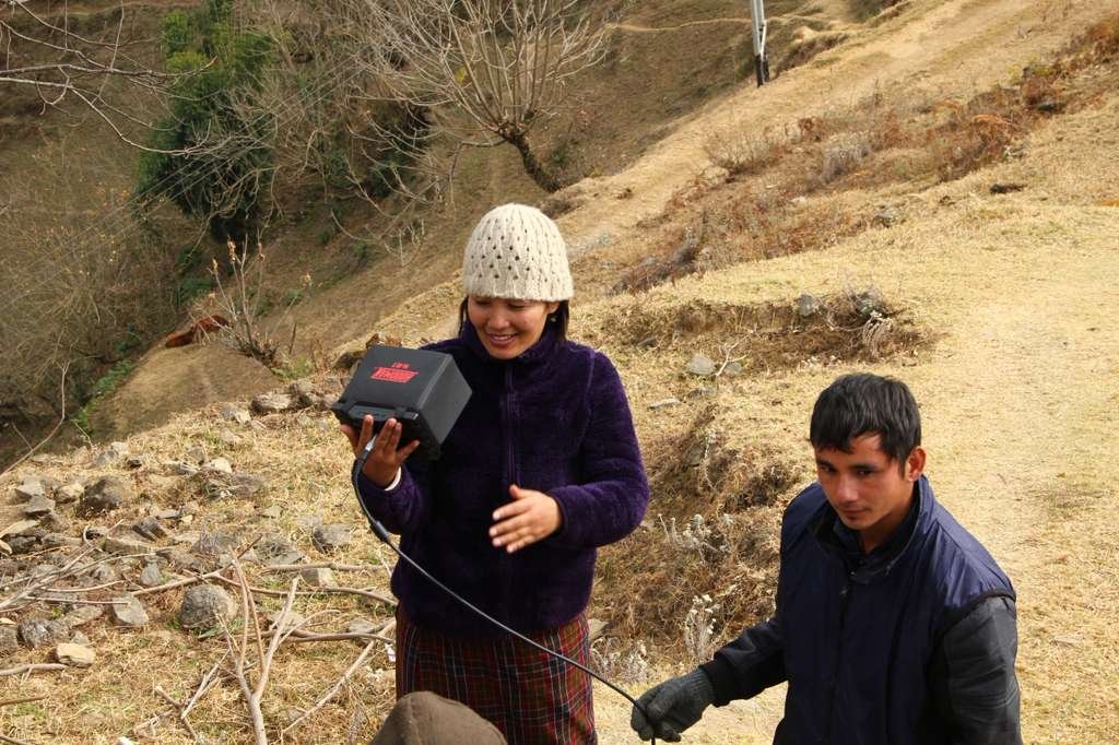 Karma Deki directing her crew on location in rural Bhutan, wearing traditional Bhutanese dress